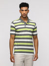 Man wearing a green sporty lemon green collared polo on a light gray background