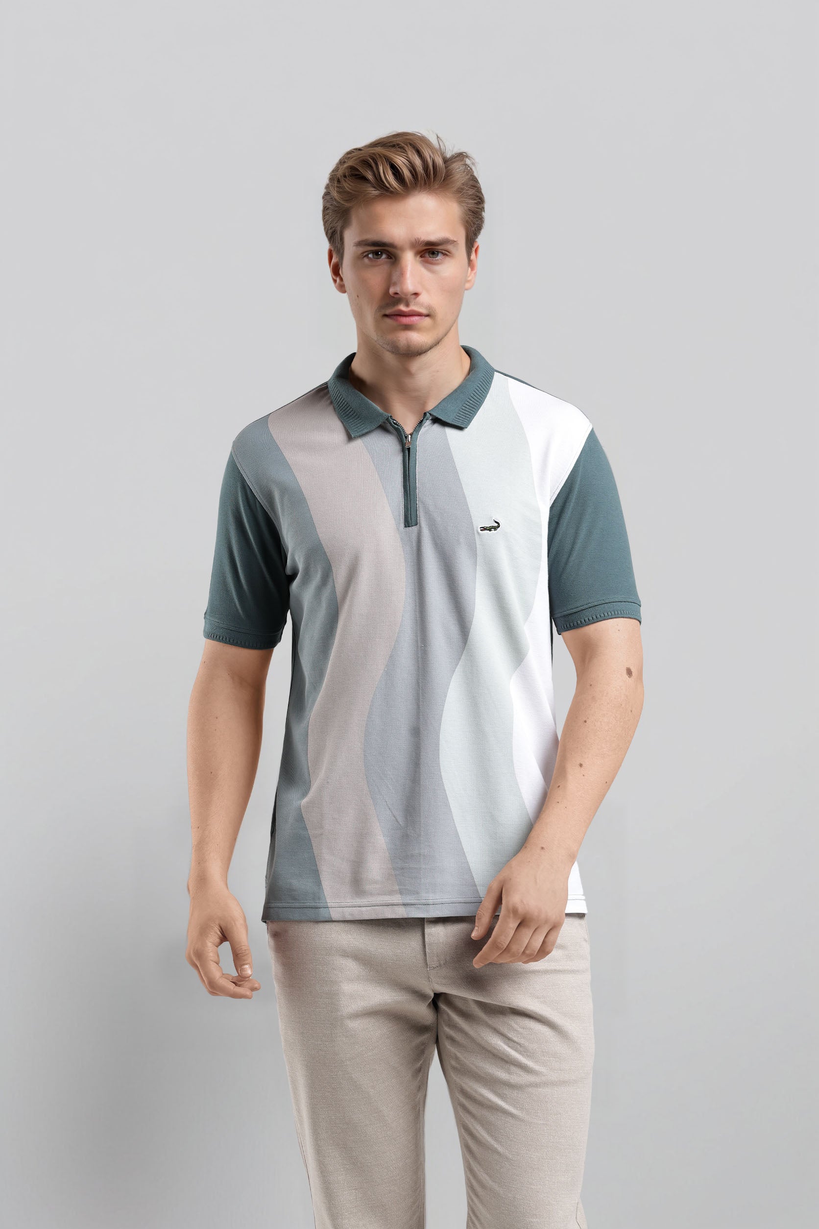 Man wearing a color-blocked polo shirt and beige pants on a gray background