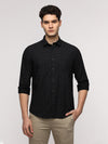 Man wearing a black full sleeve black shirt for stylish wear on a light gray background