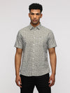 Man wearing a green half sleeve green striped shirt for trendy looks with casual styling on a gray background