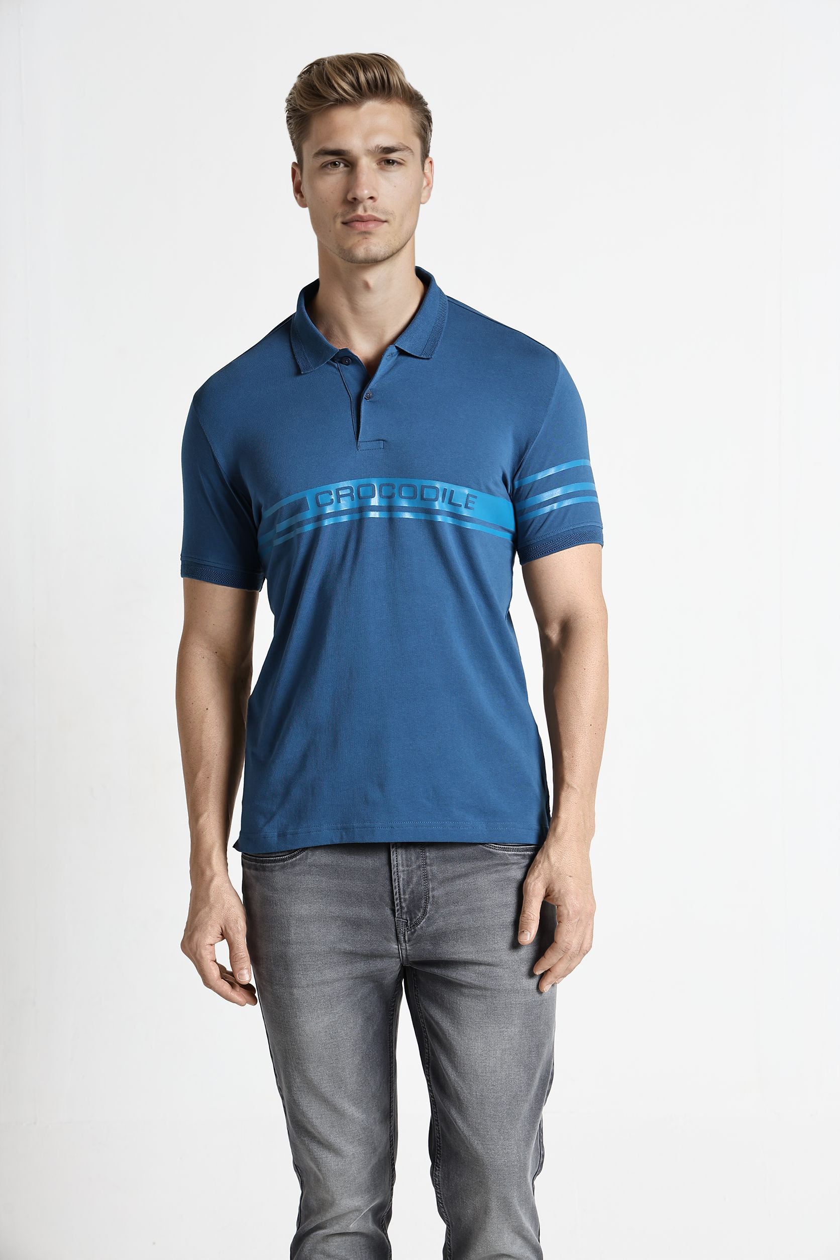 Man wearing a blue polo shirt with a brand logo on a white background