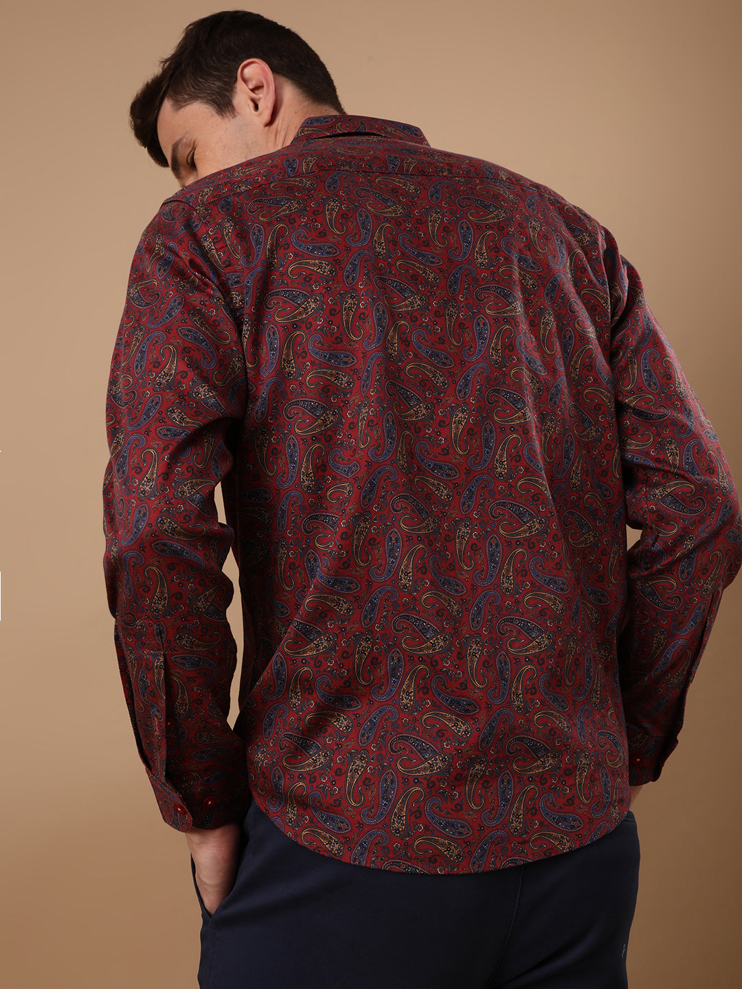 Man wearing a red red printed full sleeve 100% cotton shirt on a light gray background