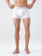 Person wearing white boxer briefs on a plain background