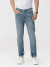 Man wearing a blue natural fade wash dark blue denim on a light gray background