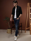 Man wearing a black black casual solid full sleeve 100% cotton shirt with casual styling on a gray background