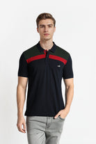 Man wearing a black polo shirt with red accents on a white background