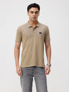 Man wearing a wood cut&sew slim fit polo t shirt on a light gray background