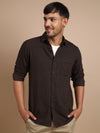 Man wearing a brown brown solid full sleeve 100% cotton shirt on a light gray background