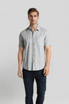 Man wearing a grey grey waffle textured melange checks comfort fit shirts with casual styling on a gray background