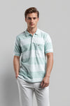 Man wearing a blue blue yarn -dyed polo t shirt comfort fit polo t shirt with casual styling on a gray background