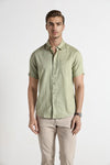 Man wearing a green green textured cozy feel cotton comfort fit shirts on a light gray background