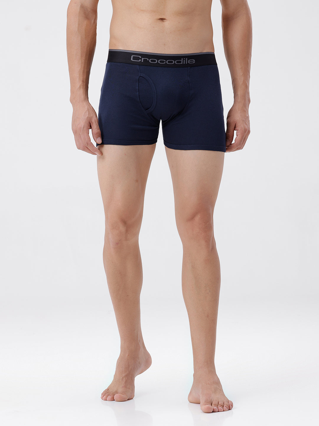 Person wearing navy blue boxer briefs with a visible brand logo on a white background
