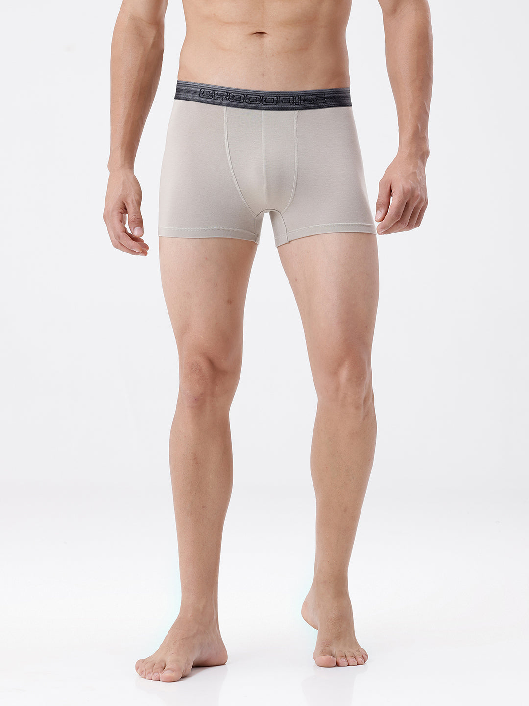 Man wearing beige boxer briefs with a white background