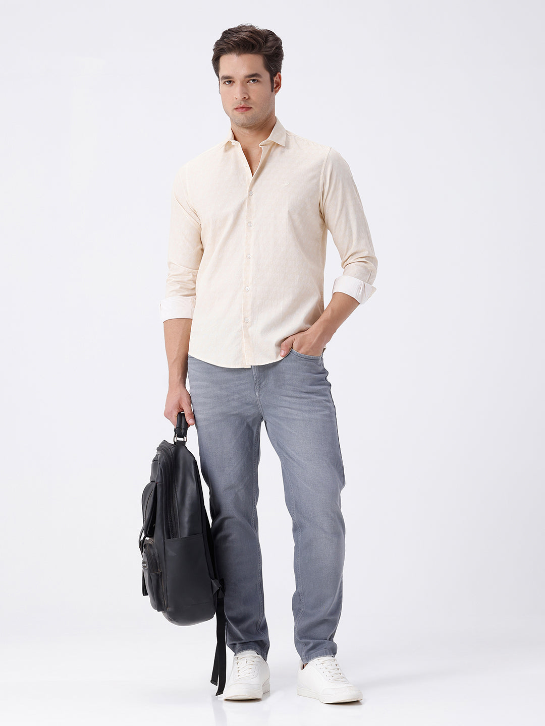Man wearing a geomentic diamond print shirt on a light gray background