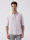Man wearing a leaf print linen shirt on a light gray background