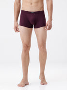 Man wearing a pair of burgundy boxer briefs on a white background
