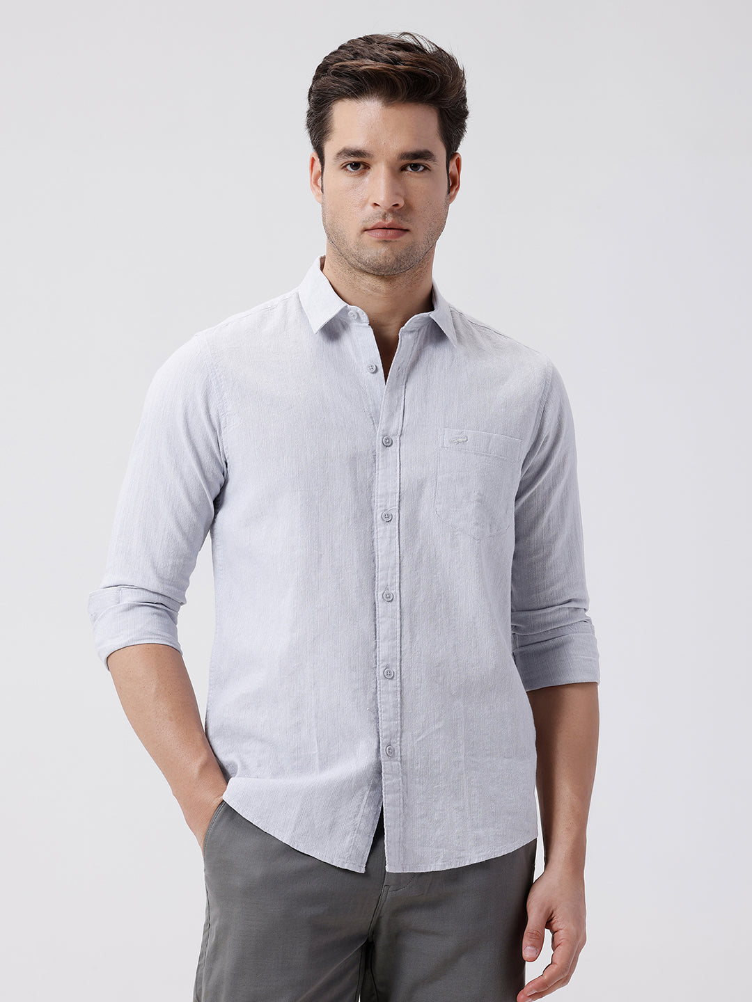 Man wearing a grey rib textured cotton shirt grey on a light gray background