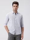 Man wearing a grey rib textured cotton shirt grey on a light gray background