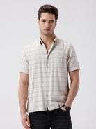 Man wearing a relax fit window pane checks shirt on a light gray background