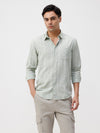 Man wearing a jacquard stripe shirt with casual styling on a gray background