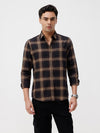 Man wearing a brown oxford checks shirt brown with casual styling on a gray background