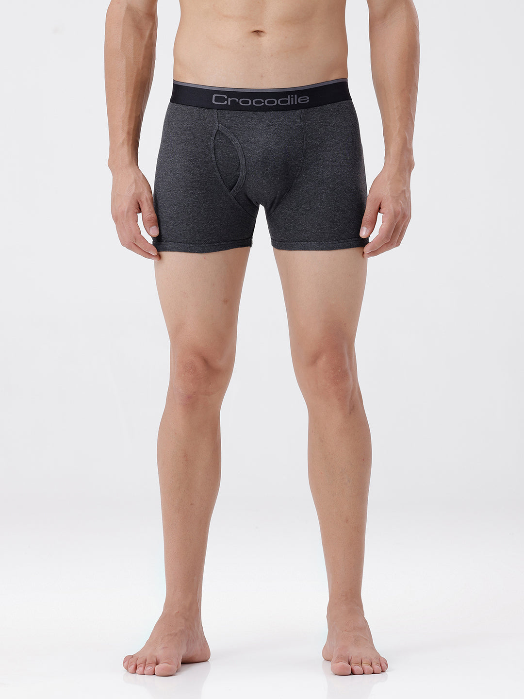 Person wearing gray boxer briefs with a brand logo on a white background