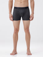Person wearing gray boxer briefs with a brand logo on a white background
