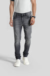 Man wearing a grey grey luxury soft premium fabric natural fade wash crocodile slim fit jeans with casual styling on a gray background
