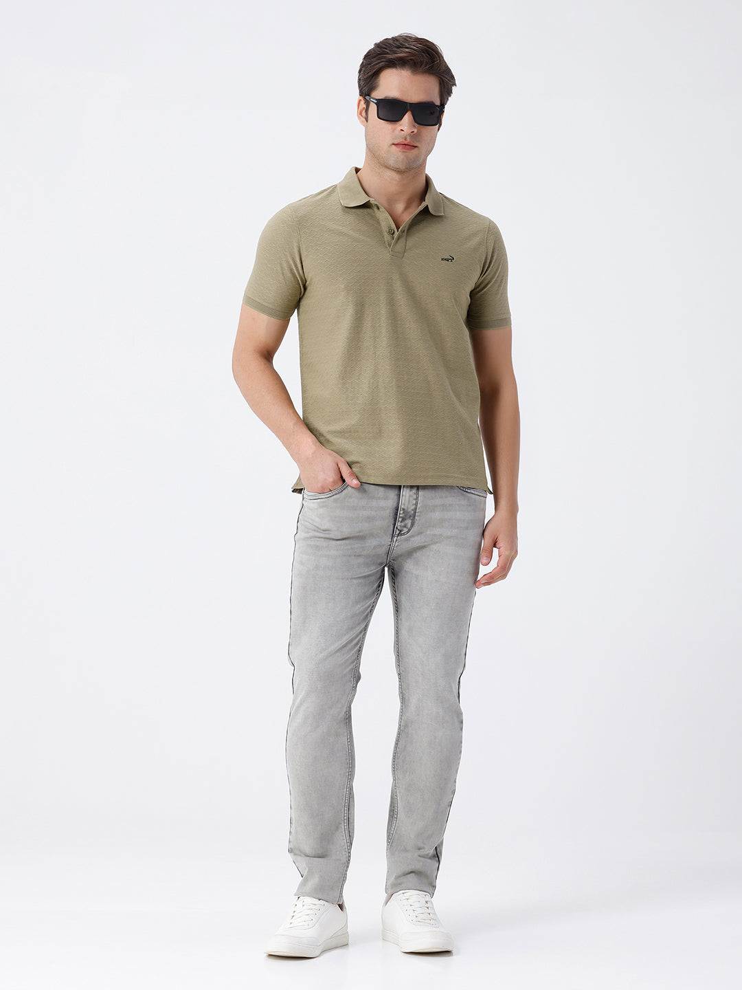 Man wearing a olive light olive structure comfort fit polo t shirt on a light gray background