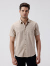 Man wearing a beige melange shirt solid beige on a light gray background