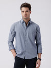 Man wearing a blue premium tri blend stripe shirt blue with casual styling on a gray background