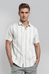 Man wearing a white white textured stripe shirt cotton fabric comfort fit shirts with casual styling on a gray background