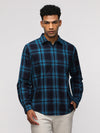 Man wearing a blue comfort fit sport blue shirt for stylish wear with casual styling on a gray background