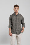 Man wearing a green green geometric horizontal self stripe cotton viscose fabric comfort fit shirts on a light gray background
