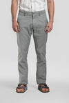 Man wearing a green green classic chambray fabric tri-blend stitch detailings slim fit trousers with casual styling on a gray background