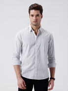 Man wearing a blue stripe textured pure cotton shirt blue on a light gray background