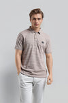 Man wearing a brown brown jacquard polo t shirt comfort fit polo t shirt on a light gray background