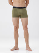 Person wearing olive green boxer briefs with a visible brand logo on a white background
