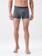 Man wearing gray boxer briefs on a white background
