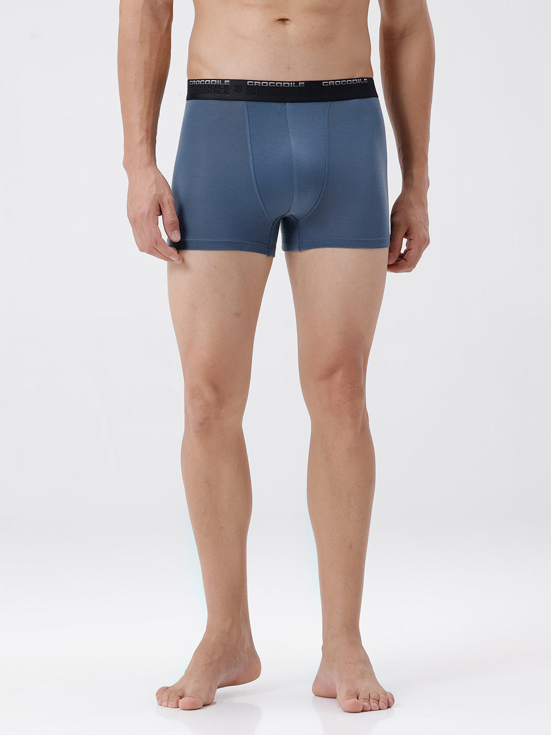 Man wearing blue boxer briefs on a white background