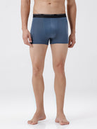 Man wearing blue boxer briefs on a white background