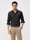 Man wearing a black black all over print slim fit casuals shirts on a light gray background
