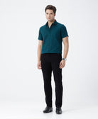 Man wearing a green pure cotton textured shirt green with casual styling on a gray background