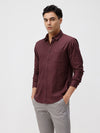 Man wearing a red pure cotton textured shirt wine on a light gray background