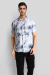 Man wearing a blue blue fluid shirt grunge print comfort fit shirts on a light gray background