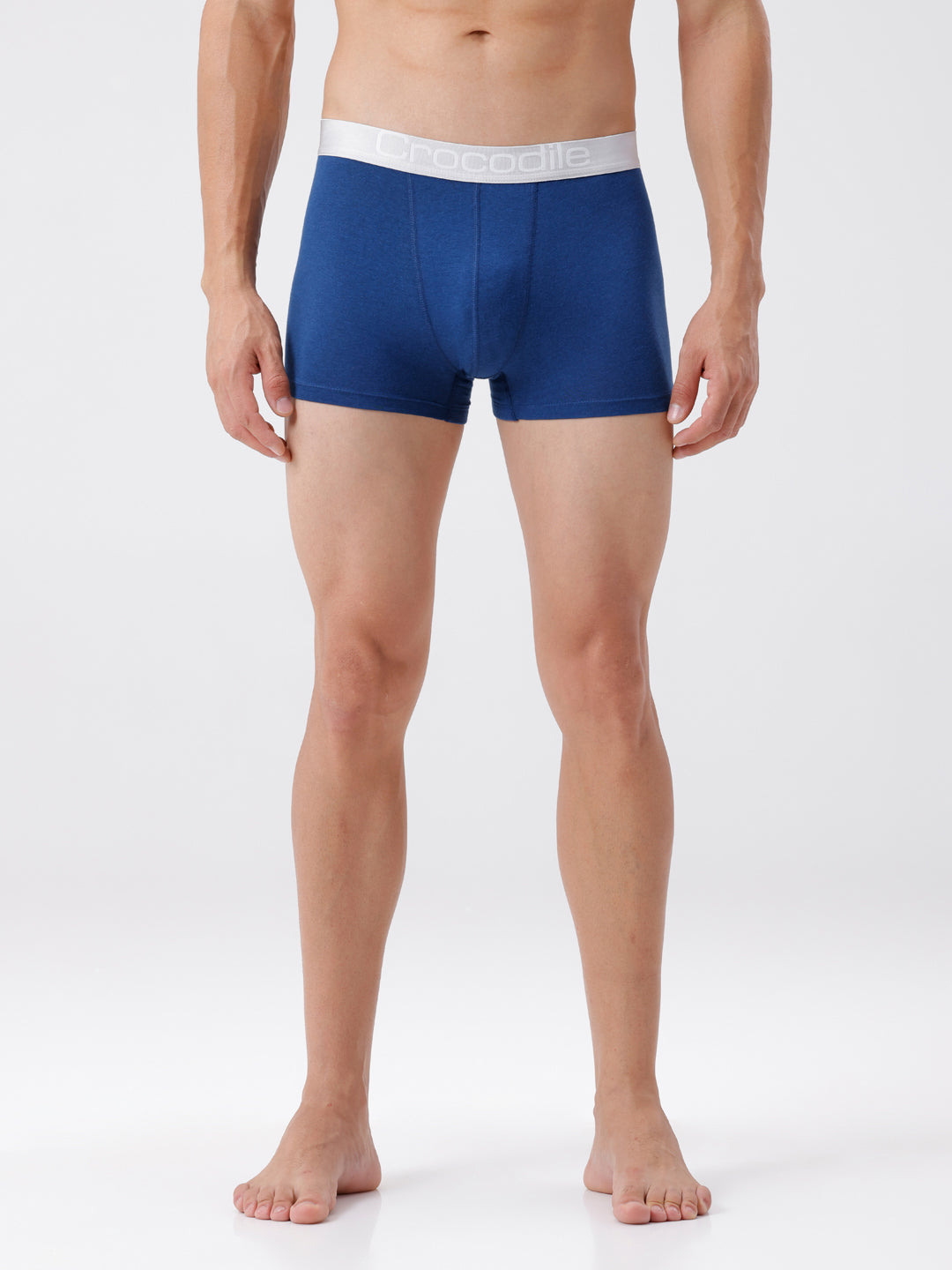 Man wearing blue boxer briefs on a white background