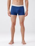 Man wearing blue boxer briefs on a white background