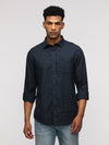 Man wearing a navy full sleeve navy checked shirt for trendy wear on a light gray background
