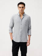 Man wearing a premium tensil linen shirt on a light gray background