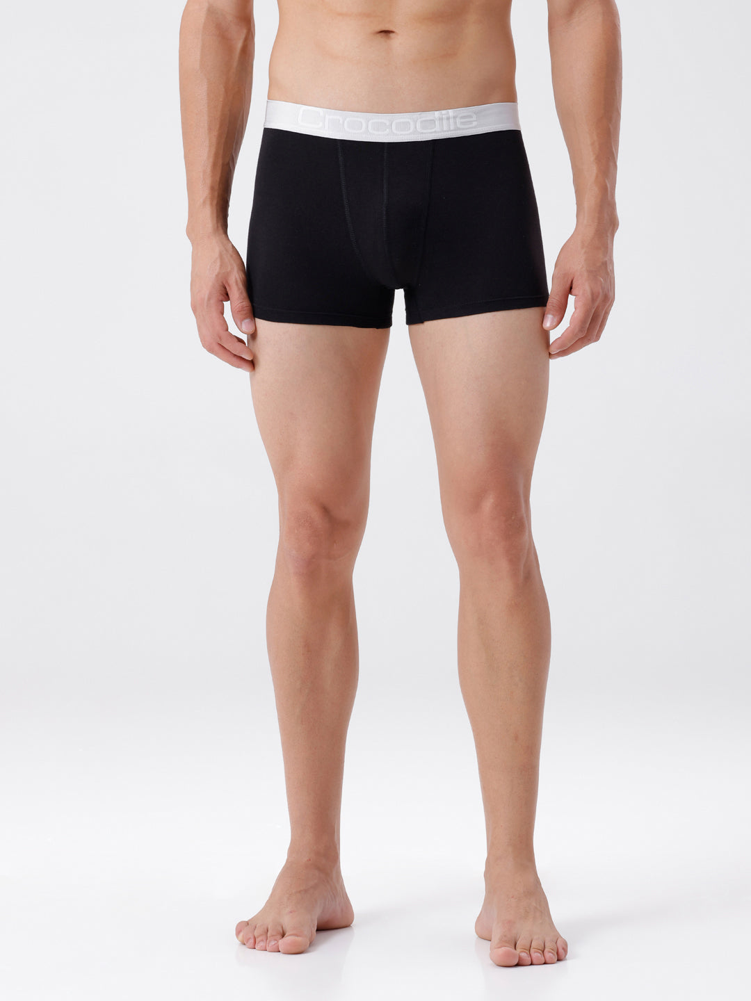 Person wearing black boxer briefs with white waistband on a white background